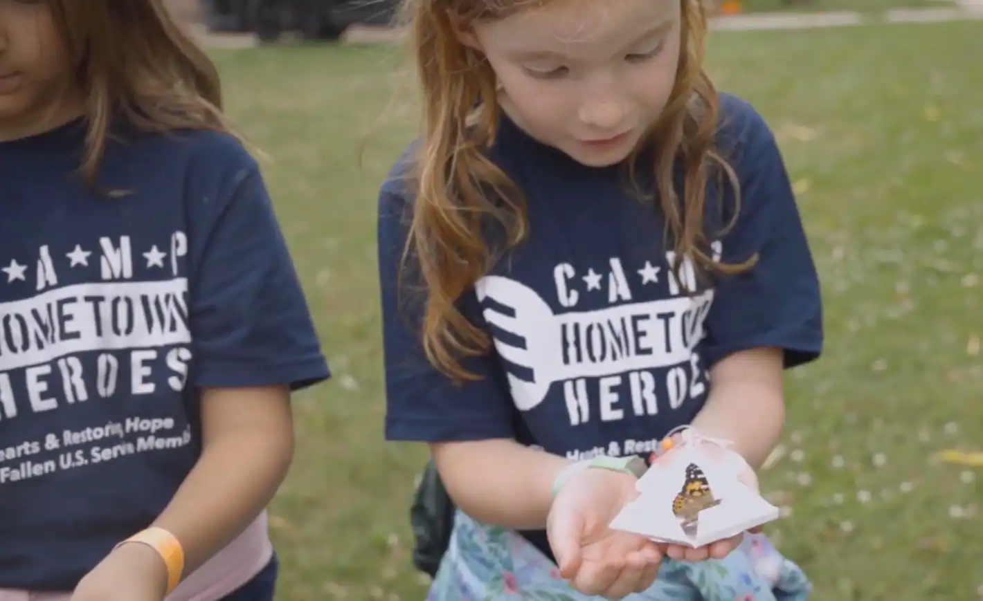 Girl holding a butterfly in her hand