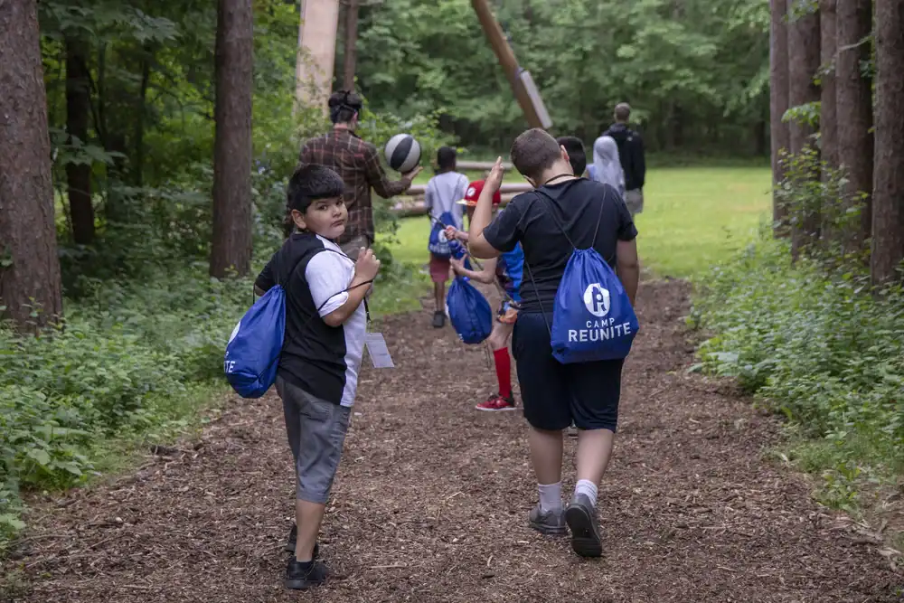 Kids walking a path through the woods