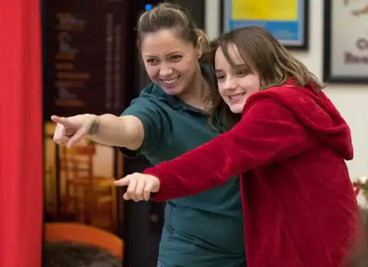 Mother pointing with daughter