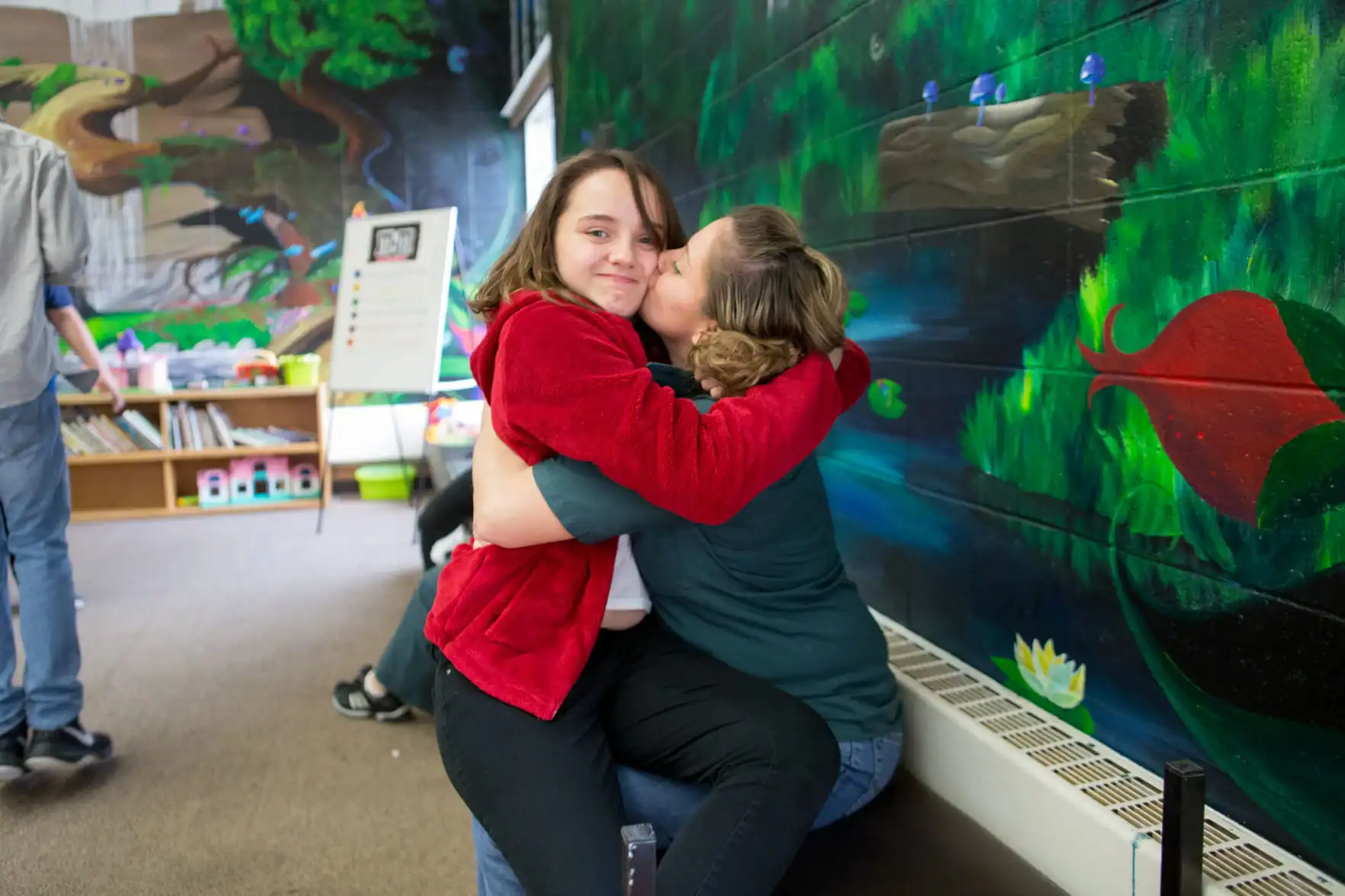 Adriana & Tiana hugging, smiling